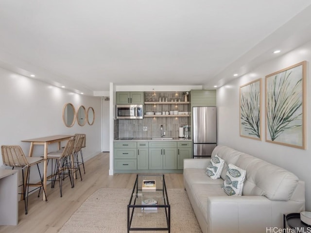 living room featuring sink and light hardwood / wood-style floors