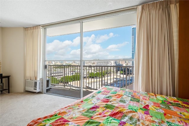 carpeted bedroom featuring expansive windows, a textured ceiling, and access to outside