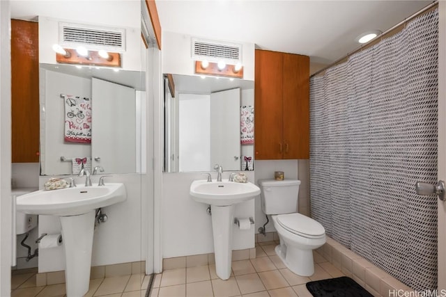 bathroom with walk in shower, tile patterned floors, and toilet