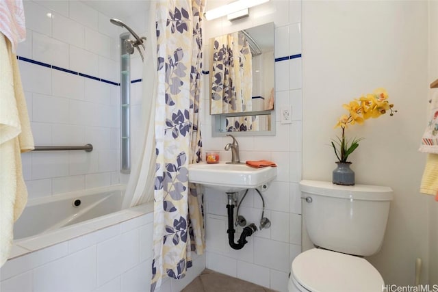 full bathroom featuring shower / bathtub combination with curtain, sink, and toilet