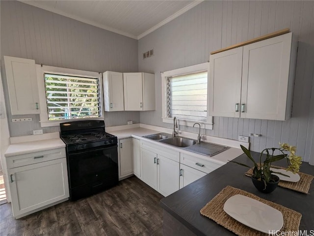 kitchen featuring black range with gas cooktop, white cabinetry, ornamental molding, a healthy amount of sunlight, and dark hardwood / wood-style flooring