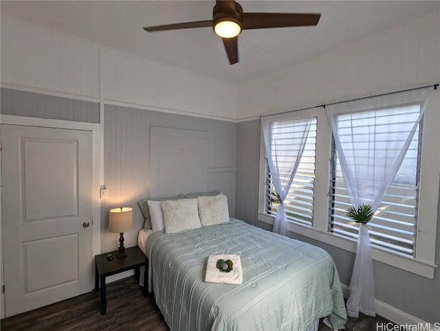 bedroom with a ceiling fan and dark wood-style flooring