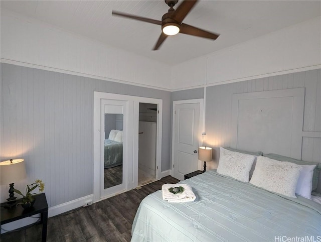 bedroom featuring dark wood-style floors, ceiling fan, and baseboards