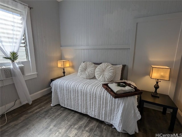 bedroom featuring baseboards, cooling unit, and dark wood-style flooring