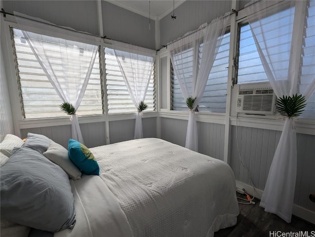 bedroom with cooling unit and multiple windows