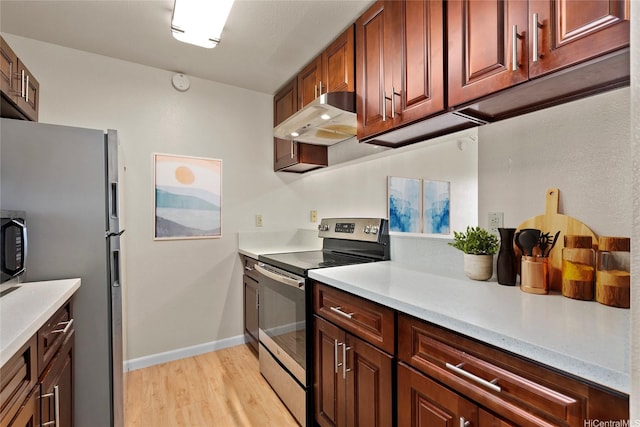 92-1150 Hame St Unit 8205, Kapolei, HI 96707 - kitchen with stainless steel appliances, under cabinet range hood, light wood-style flooring, light countertops, and baseboards