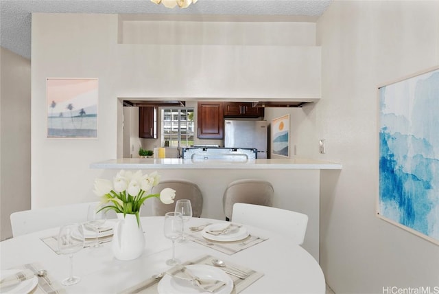 dining area with a textured ceiling