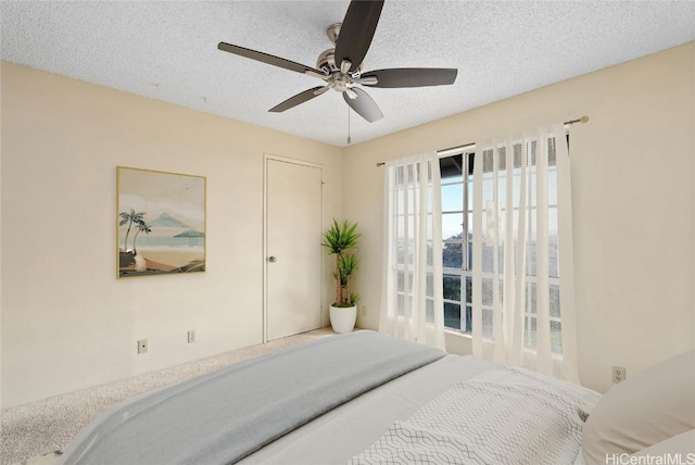 bedroom featuring a textured ceiling and ceiling fan