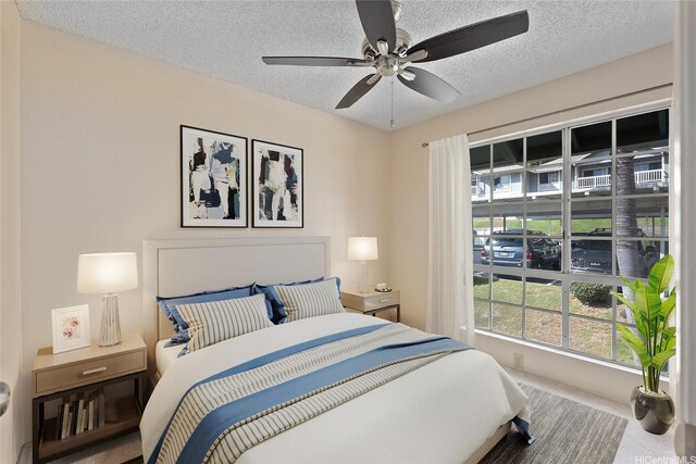 92-1150 Hame St Unit 8205, Kapolei, HI 96707 - carpeted bedroom with a textured ceiling and ceiling fan