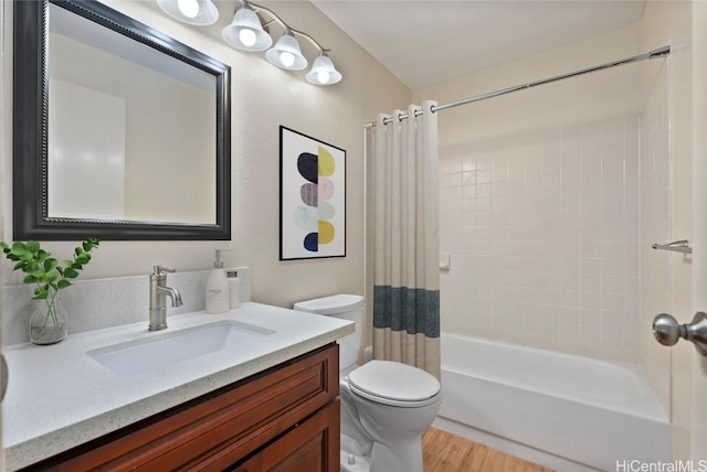 full bathroom featuring hardwood / wood-style floors, vanity, toilet, and shower / bathtub combination with curtain