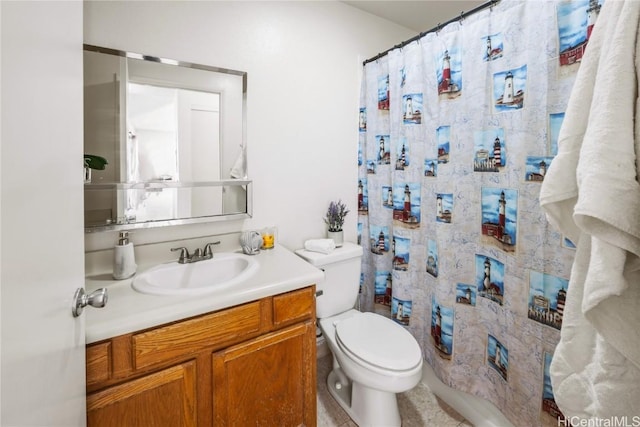 bathroom featuring toilet, a shower with shower curtain, and vanity