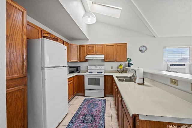 kitchen with sink, white appliances, light tile patterned flooring, kitchen peninsula, and vaulted ceiling with skylight