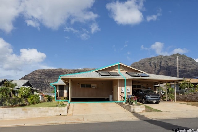 view of front facade with a carport and a mountain view