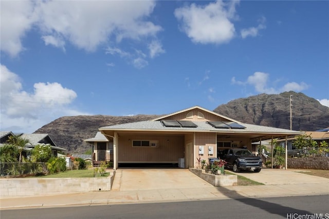 view of front of home with a carport and a mountain view