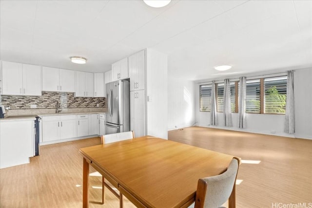 dining area featuring sink and light hardwood / wood-style floors