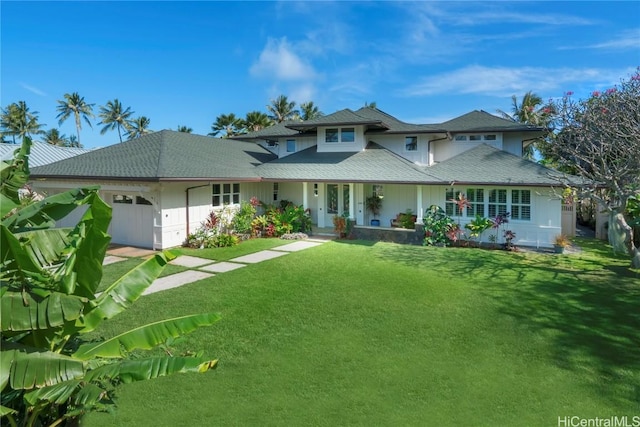 view of front of property featuring a garage and a front yard