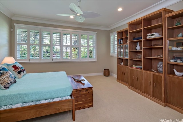 carpeted bedroom featuring ceiling fan and ornamental molding