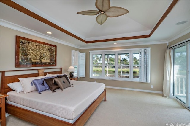 bedroom with access to outside, ceiling fan, a tray ceiling, and ornamental molding