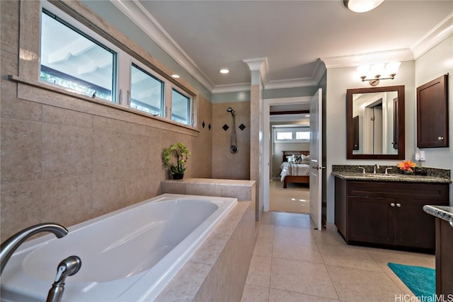 bathroom with plus walk in shower, a wealth of natural light, tile patterned floors, and vanity