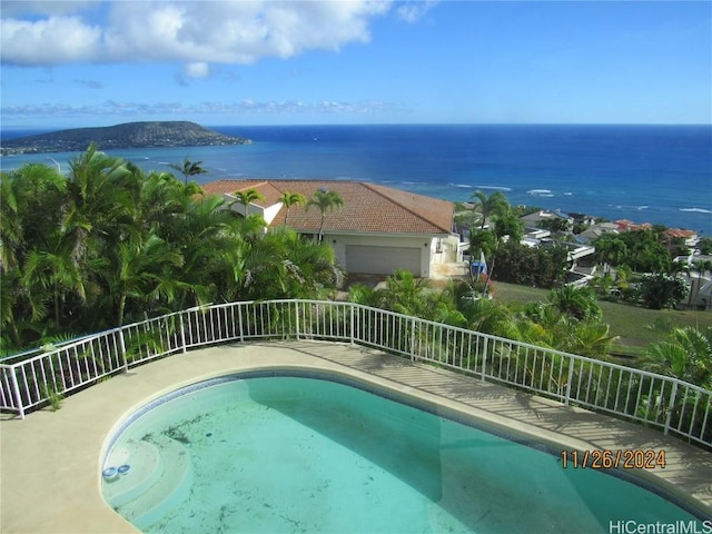 view of swimming pool featuring a water view