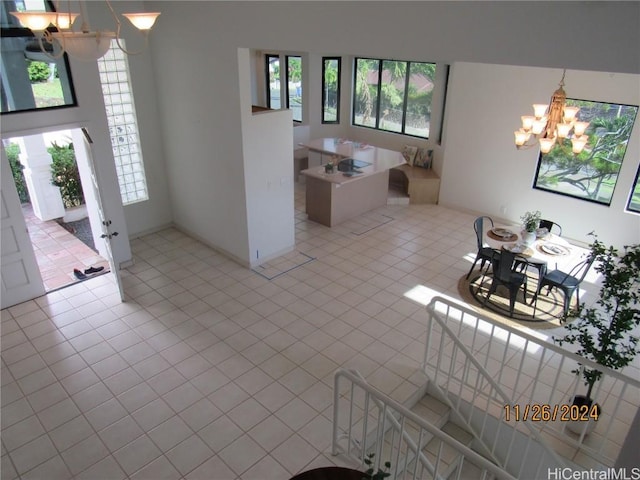 foyer with a chandelier and light tile patterned flooring