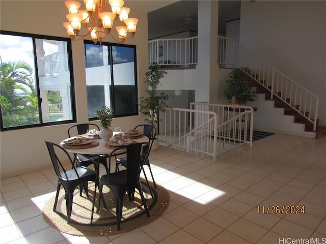 dining space featuring light tile patterned floors and a chandelier