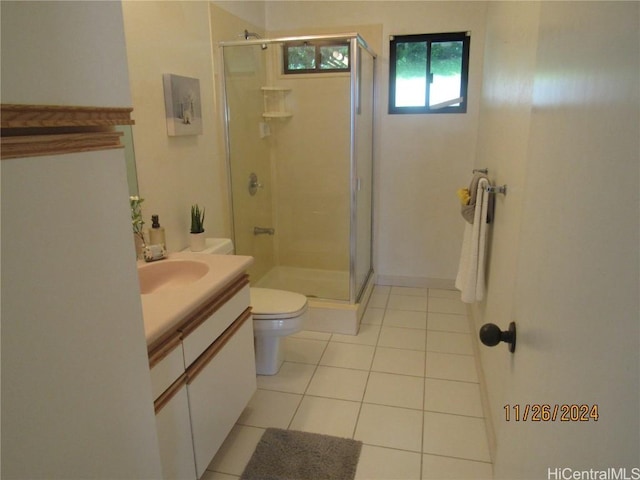 bathroom with tile patterned floors, vanity, toilet, and an enclosed shower