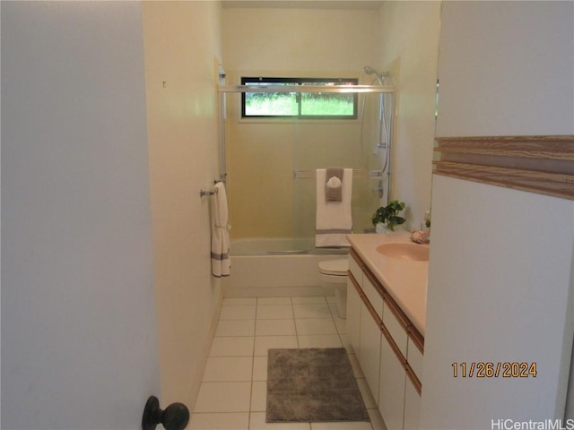 full bathroom with tile patterned flooring, vanity, combined bath / shower with glass door, and toilet