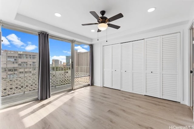 unfurnished bedroom with access to outside, ceiling fan, and light hardwood / wood-style floors