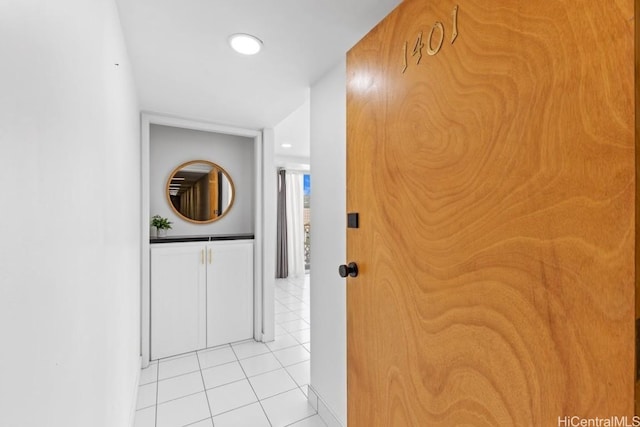 hall featuring light tile patterned flooring