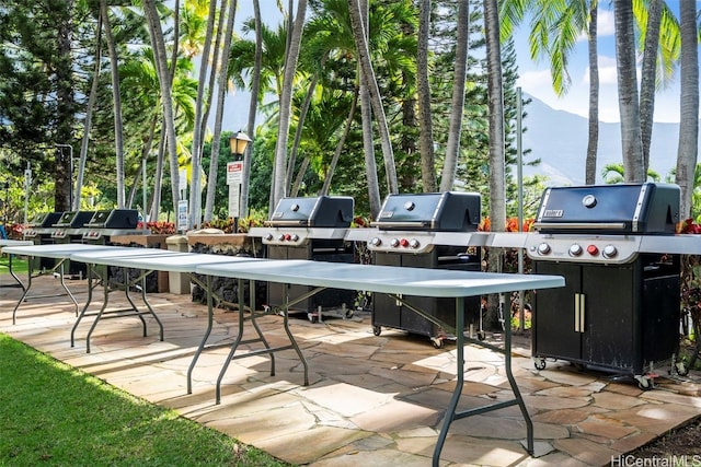 view of patio with grilling area and a mountain view