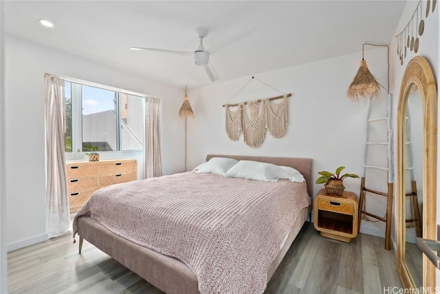 bedroom with hardwood / wood-style floors and ceiling fan