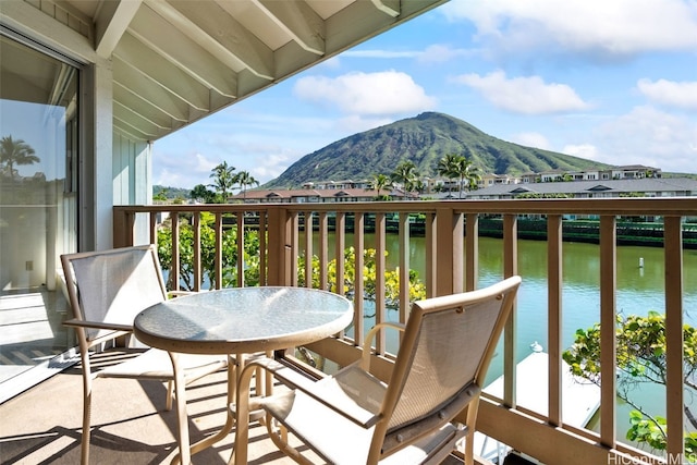 balcony featuring a water and mountain view