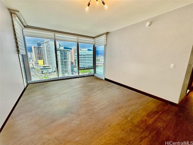 unfurnished room with plenty of natural light and floor to ceiling windows