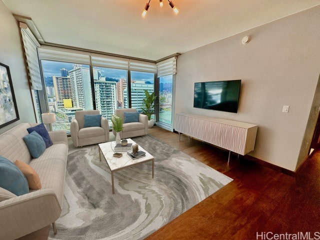 living room featuring plenty of natural light, dark wood-type flooring, and a chandelier