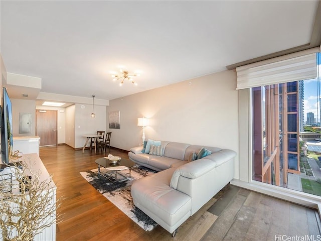 living room featuring a wall of windows and wood finished floors