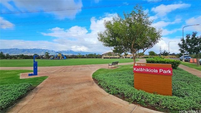 view of property's community featuring a mountain view and a yard