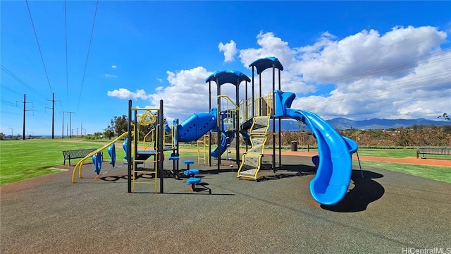 view of playground with a mountain view and a lawn