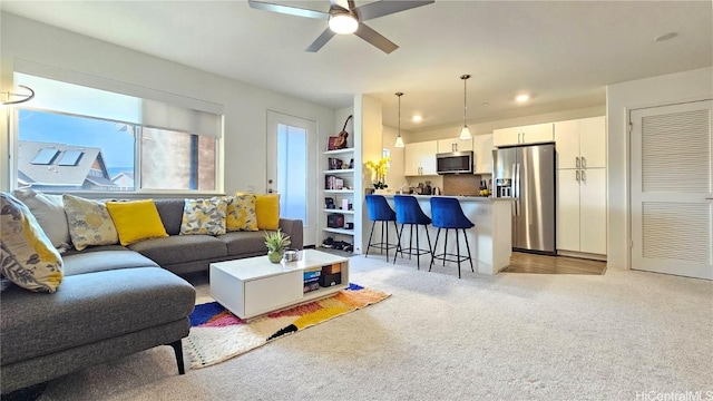 living room featuring ceiling fan and light carpet