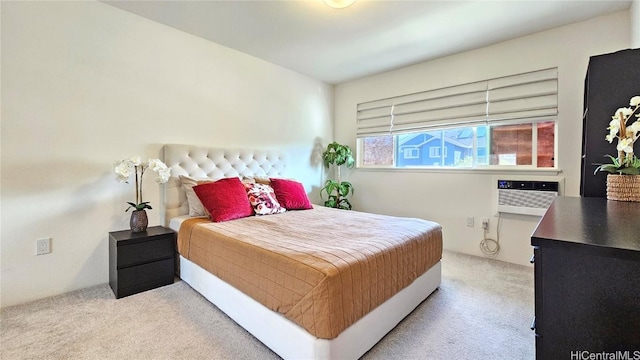 bedroom featuring light carpet and an AC wall unit