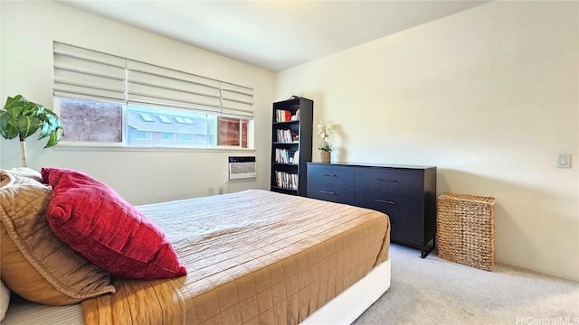 bedroom featuring a wall unit AC and light colored carpet