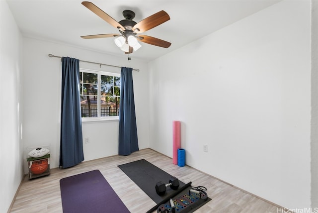 workout area with light wood-type flooring and ceiling fan