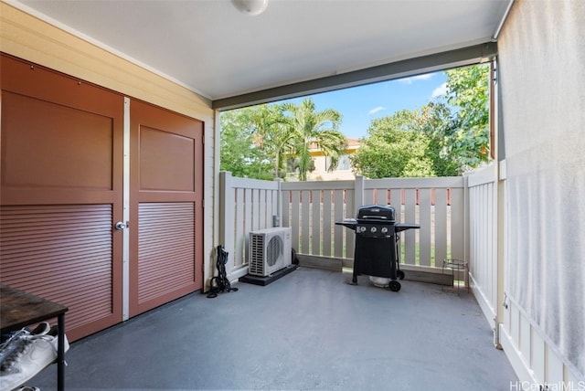 unfurnished sunroom featuring ac unit