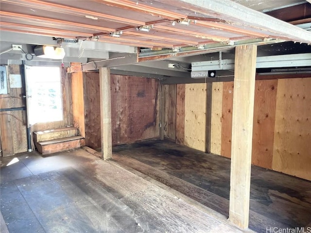 basement featuring wood walls