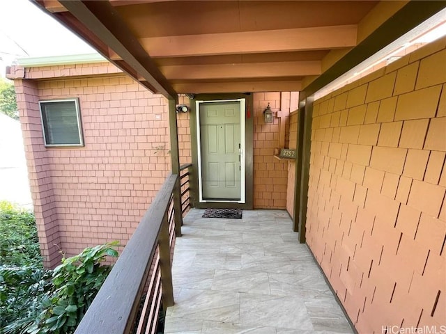 entrance to property featuring a balcony