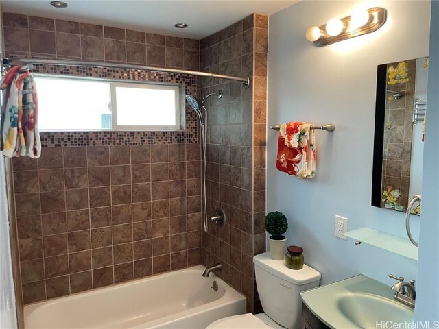 full bathroom with vanity, toilet, and tiled shower / bath