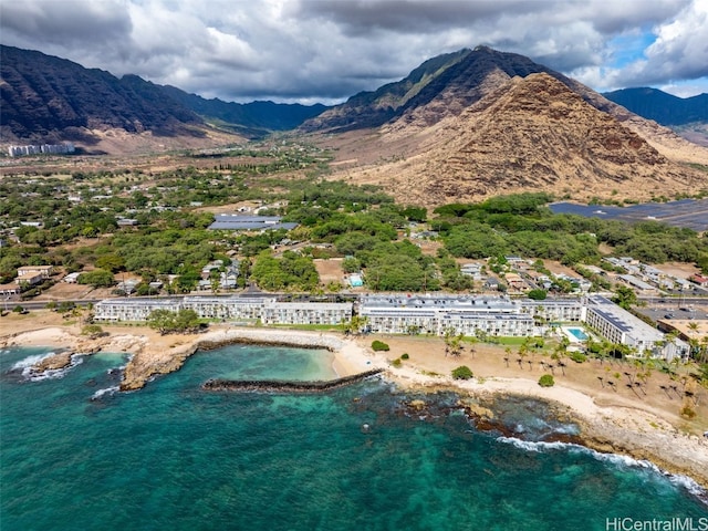 drone / aerial view featuring a water and mountain view