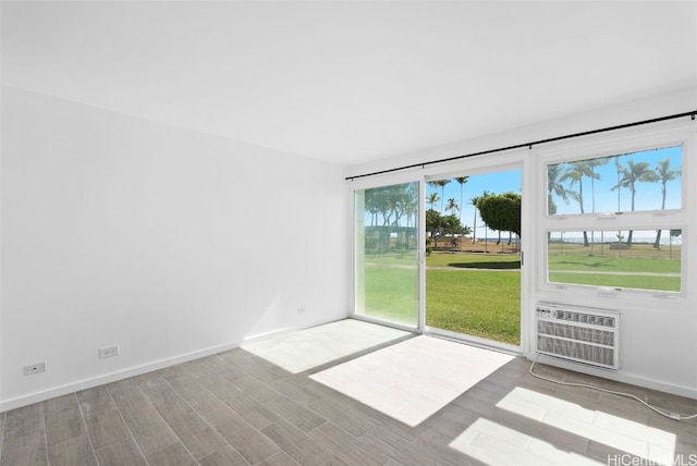 unfurnished room featuring a wall mounted air conditioner