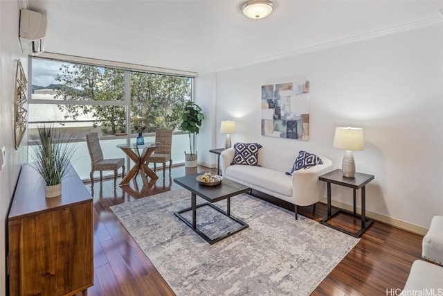 living room with a wall unit AC, a wall of windows, ornamental molding, baseboards, and dark wood finished floors