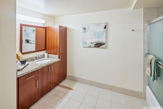 bathroom with tile patterned flooring, vanity, and enclosed tub / shower combo